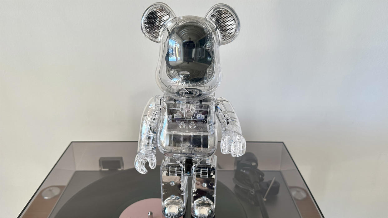  The BE@RBRICK Audio stood on top of a vinyl player . 