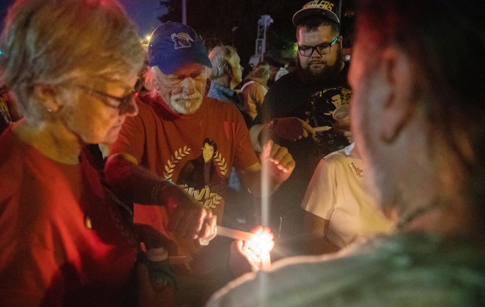 Fans light candles during the Candlelight Vigil ceremony marking the 45th anniversary of Elvis Presley's death Monday, Aug. 15, 2022, at Graceland in Memphis.