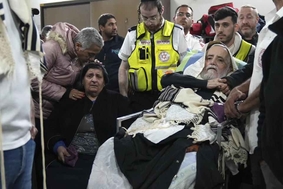 Mourners comfort the parents of Tamir Avihai, 50, at his funeral in the West Bank Israeli settlement of Barkan, Tuesday, Nov. 15, 2022. A Palestinian killed three Israelis, including Avihai and wounded three others in an attack in a settlement in the occupied West Bank on Tuesday before he was shot and killed by Israeli security personnel, Israeli paramedics and Palestinian officials said. (AP Photo/ Tsafrir Abayov)