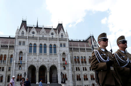 Two soldiers stand in front of the Hungarian Parliament building in Budapest, Hungary, May 29, 2018. REUTERS/Bernadett Szabo