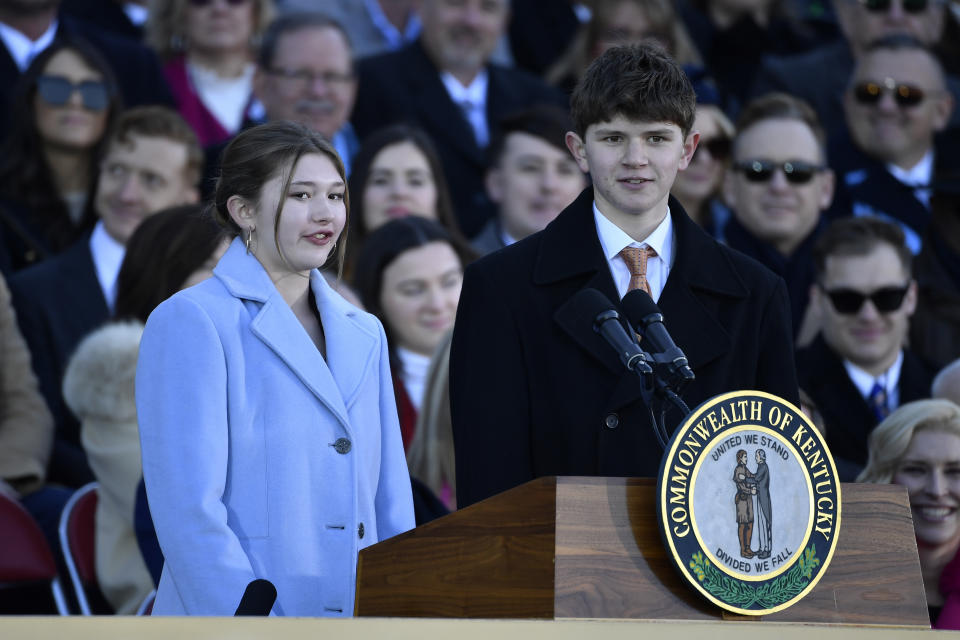 Lila Beshear, left, and her brother Will Beshear speak to the audience gathered on the steps of the Kentucky State Capitol to witness the public swearing in ceremony of their father, Kentucky Governor Andy Beshear in Frankfort, Ky., Tuesday, Dec. 12, 2023. (AP Photo/Timothy D. Easley)