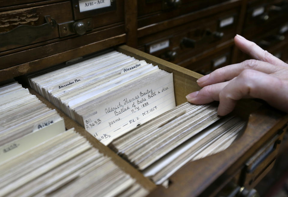 Reference Librarian Carol Tatian looks through a card catalog at the Providence Athenaeum, in Providence, R.I. on Monday, July 15, 2013. With roots dating back to 1753, the private library is one of the oldest in the country. It is housed in a Greek Revival-style granite building that neighbors Brown University and the Rhode Island School of Design. (AP Photo/Steven Senne)