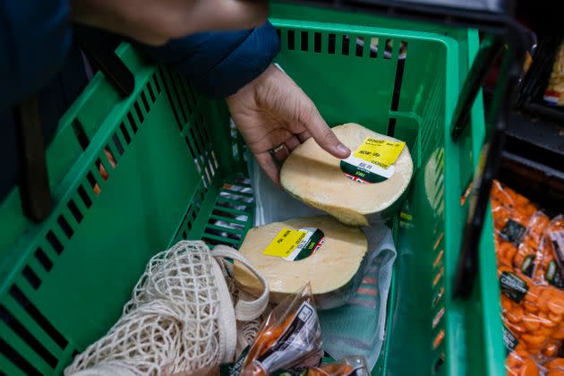 Close up of a man shopping in a supermarket while on a budget. 