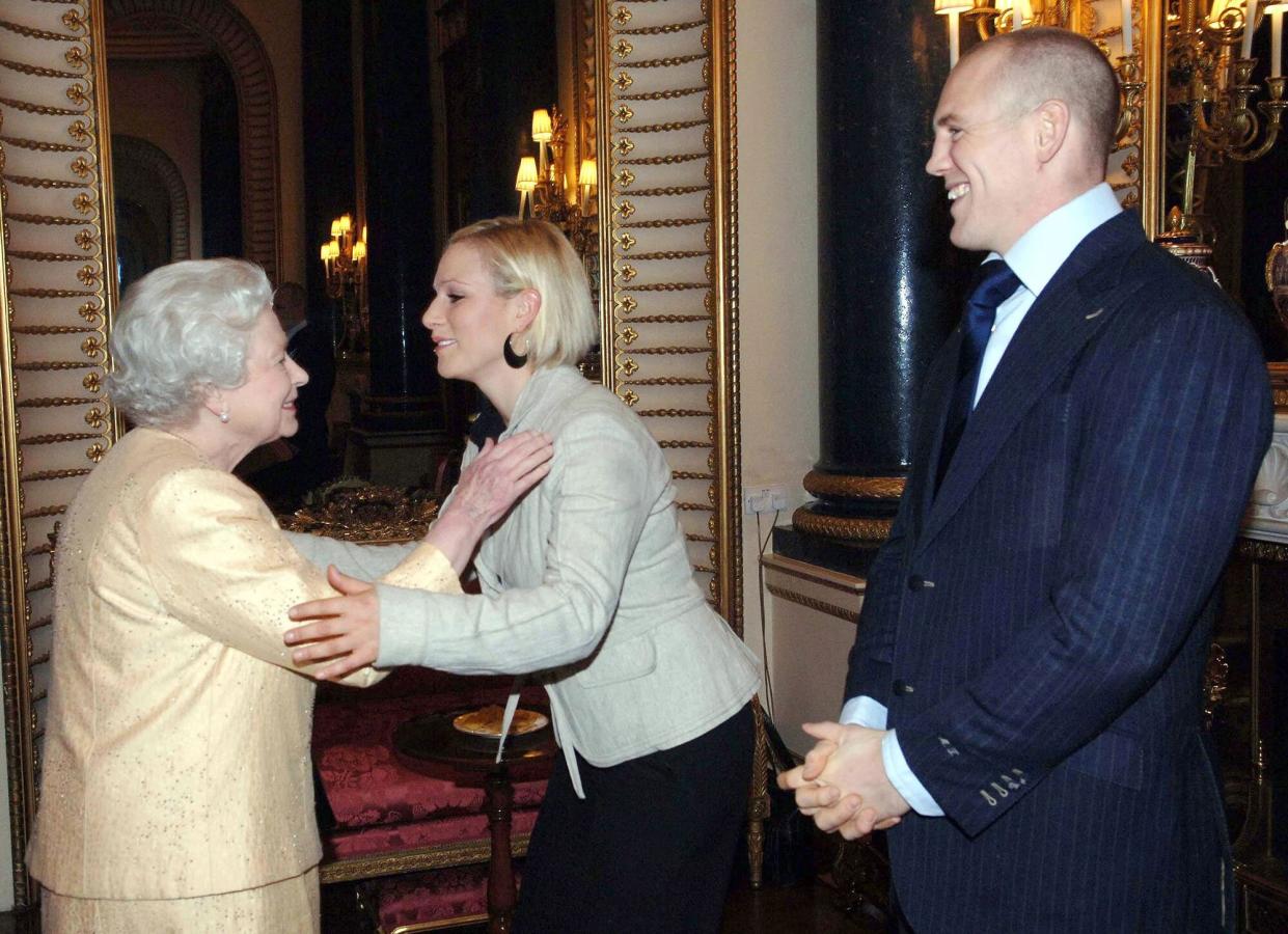 Queen Elizabeth ll greets her granddaughter, Zara Phillips, and boyfriend, English rugby player Mike Tindall, at a Buckingham Palace reception for the country's top achievers on December19, 2006 in London