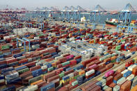 In this aerial photo, shipping containers are seen at a container port in Qingdao in eastern China's Shandong Province, Friday, Feb. 19, 2021. Chinese leaders are shifting focus from the coronavirus back to long-term goals of making China a technology leader at this year's highest-profile political event, the meeting of its ceremonial legislature, amid tension with Washington and Europe over trade, Hong Kong and human rights. (Chinatopix via AP)