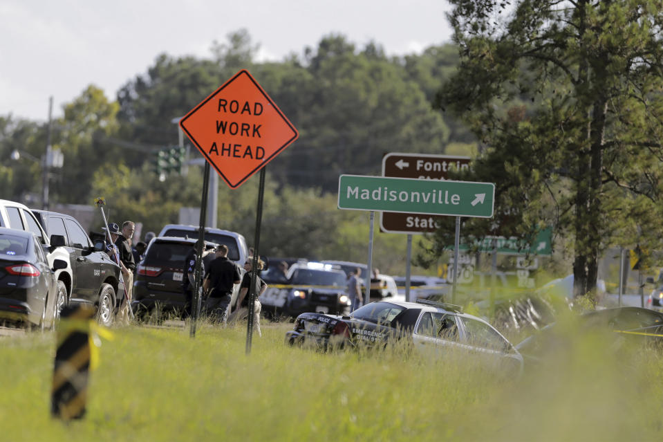 A Mandeville police car is covered with a tarp, after two Mandeville police officers were shot after a vehicle chase, one fatally, near the U.S. 190 and Louisiana Highway 22 exit in Mandeville, La., Friday, Sept. 20, 2019. Mandeville Police Chief Gerald Sticker says one officer was killed and the other was wounded Friday but expected to survive the shooting in that community on the north shore of Lake Pontchartrain. (David Grunfeld/The Advocate via AP)