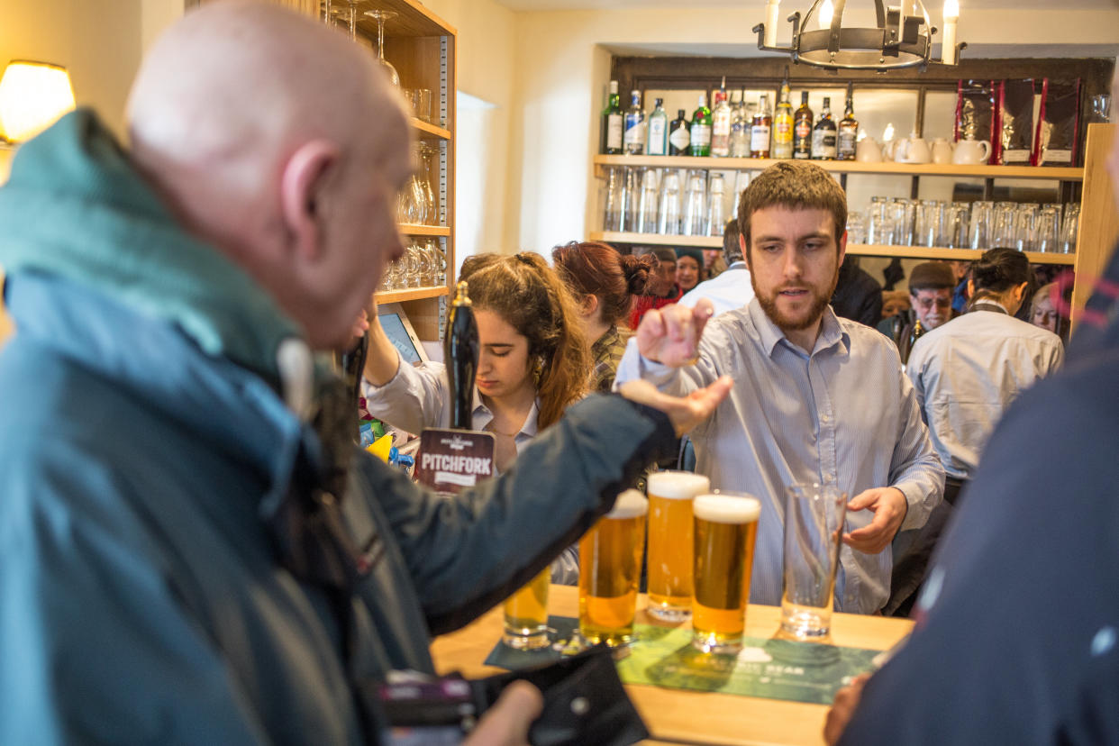 Locals queue up to get a pint in the newly reopened Packhorse Inn (SWNS.com)