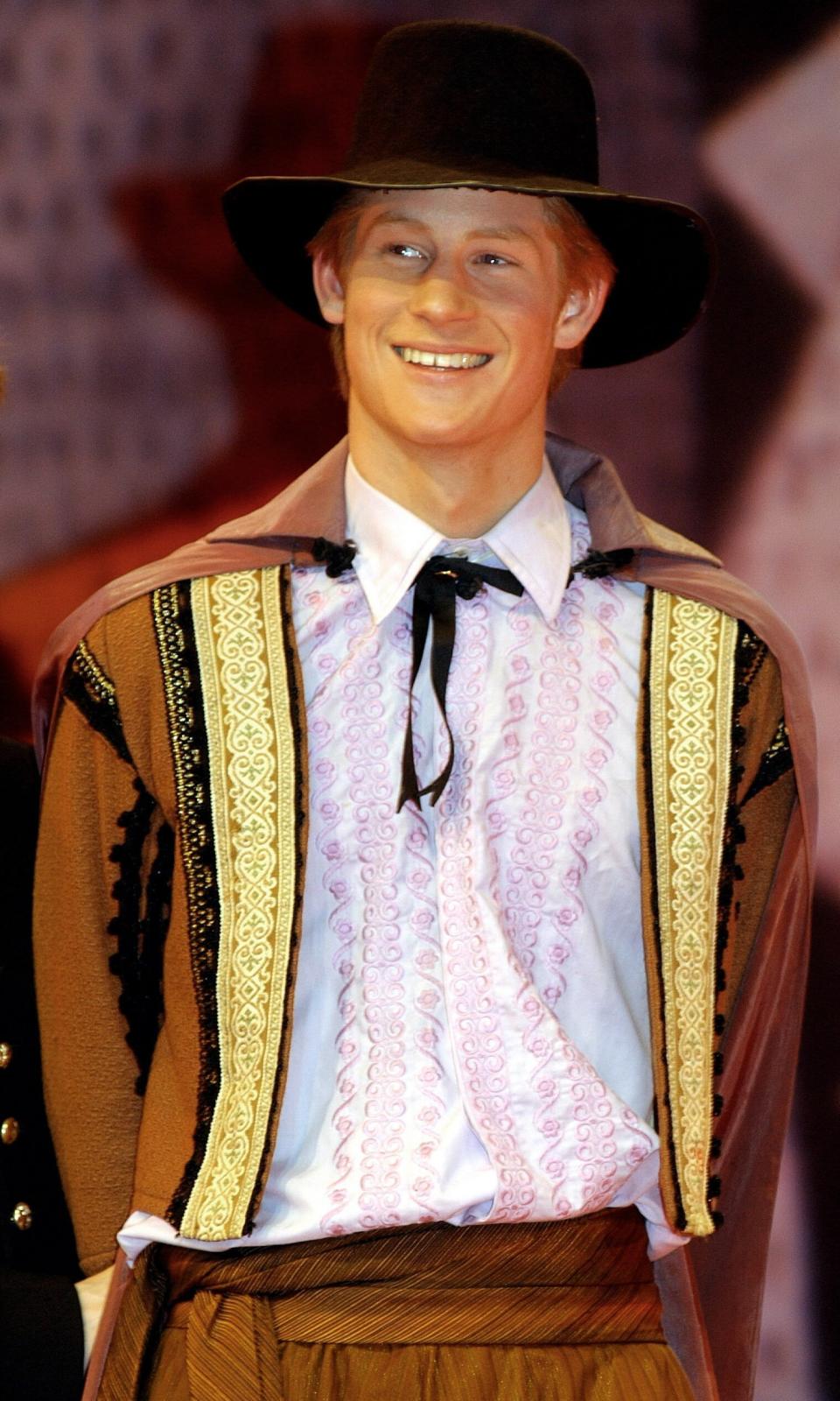 Prince Harry acts in a masked ball scene in a production of "Much Ado About Nothing" at Eton College in March 2003.