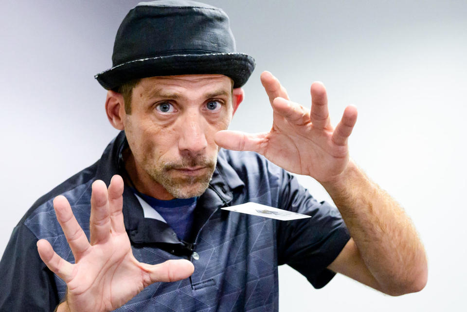 Paul Carpenter, a New Orleans magician, performs card tricks during an interview in New Orleans on Friday. (Matthew Hinton / AP)