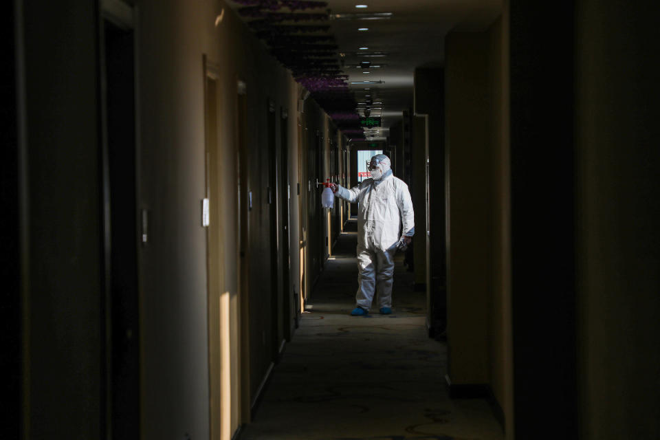 A medical worker disinfects a hotel converted into a quarantine zone in Wuhan, on Feb. 3 | AFP/GETTY IMAGES