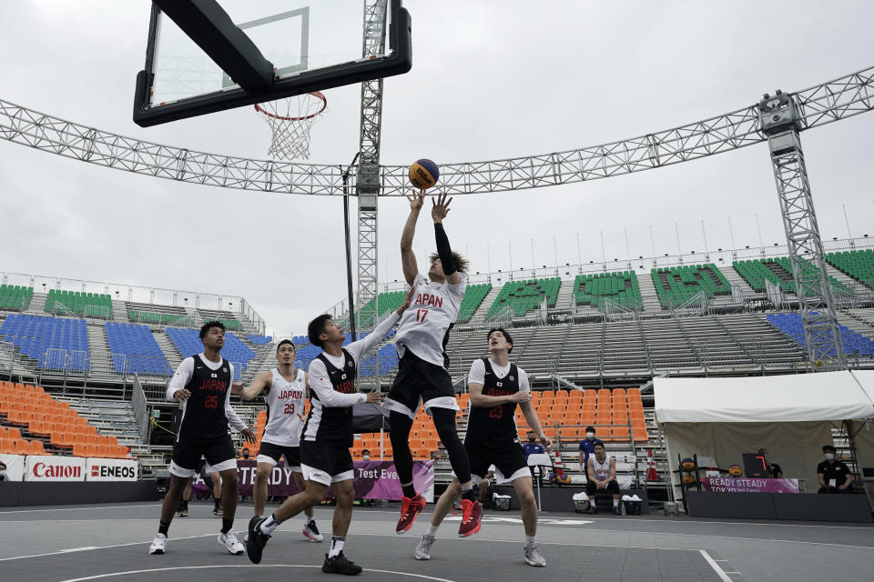 FILE - In this May 16, 2021, file photo, athletes compete during the Tokyo 2020 Olympic Game men's basketball 3x3 test event at Aomi Urban Sports Park in Tokyo. The latest stop on the perennial search for a younger, more attention-span-challenged audience for the Olympics might look familiar — the blacktop, and 3-on-3 basketball. (AP Photo/Eugene Hoshiko, File)