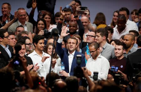 French Economy Minister Emmanuel Macron waves as he attends a political rally for his recently launched political movement, En Marche!, or Forward!, in Paris, France, July 12, 2016. REUTERS/Benoit Tessier