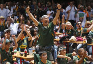 South Africa fans watching a giant screen at the Nelson Mandela Square in Johannesburg, South Africa, celebrate South Africa scoring points during the Rugby World Cup final between South Africa and England being played in Tokyo, Japan on Saturday Nov. 2, 2019. South Africa defeated England 32-12. (AP Photo/Denis Farrell)