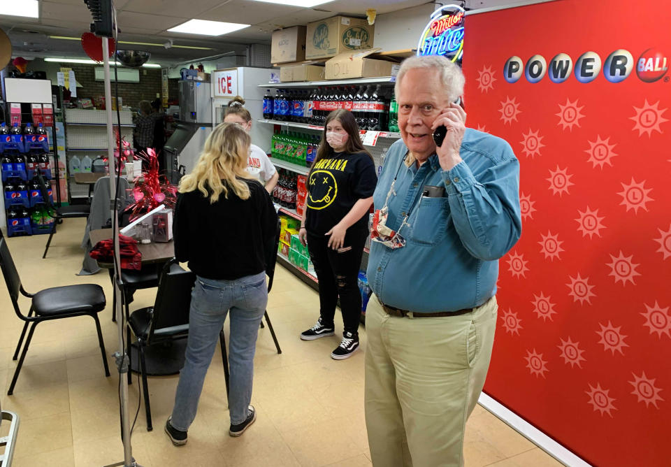 Store owner Richard Ravenscroft talks on a phone inside the Coney Market in Lonaconing Md., Thursday, Jan. 21, 2021, where a jackpot-winning Powerball ticket worth $731 million was sold this week. (Colin Campbell/The Baltimore Sun via AP)