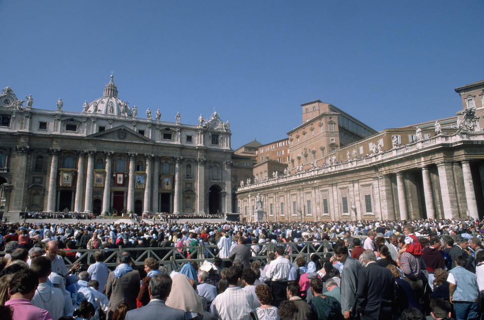 Crowded St. Peter's Square at the Vatican with the basilica in the background. People gathered for an event
