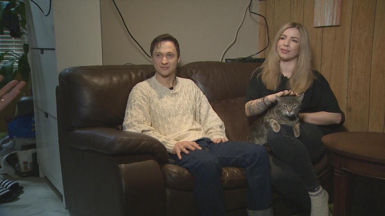 Andrii Batitskii and his wife Kateryna Bondarenko in their Surrey home. The couple hope to extend their visa and eventually get permanent residency in Canada.  (CBC - image credit)