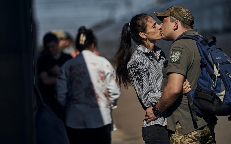 A Ukrainian soldier says goodbye to a loved one at the station closest to the frontline on September 22, 2023 in Donetsk Region, Kramatorsk Ukraine.