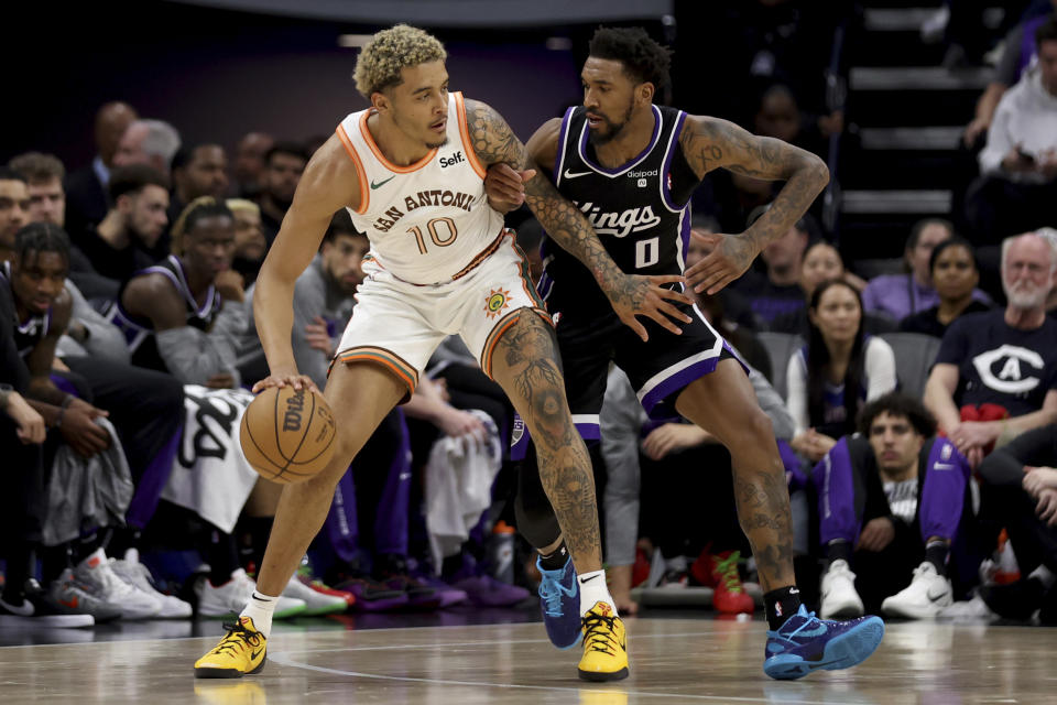 San Antonio Spurs forward Jeremy Sochan (10) is defended by Sacramento Kings guard Malik Monk (0) during the first half of an NBA basketball game in Sacramento, Calif, Thursday, March 7, 2024. (AP Photo/Jed Jacobsohn)
