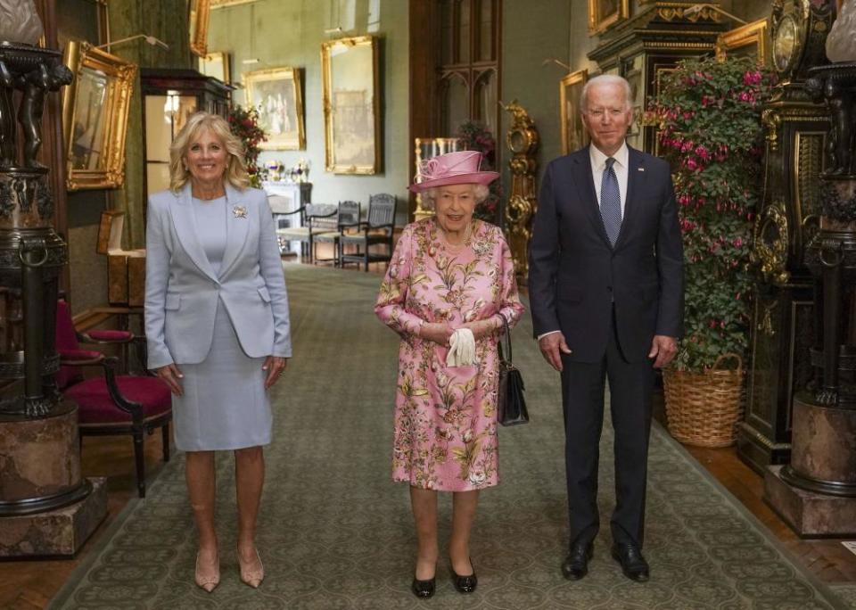 Queen Elizabeth with Joe Biden and Jill Biden in the Grand Corridor at Windsor Castle on Sunday.