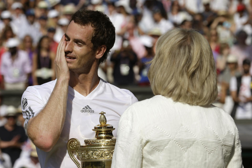 FILE - In this July 7, 2013, file photo, Andy Murray of Britain, left, reacts as he addresses spectators after he defeated Novak Djokovic of Serbia during the men's singles final match at the All England Lawn Tennis Championships in Wimbledon, London. (AP Photo/Anja Niedringhaus, Pool, File)