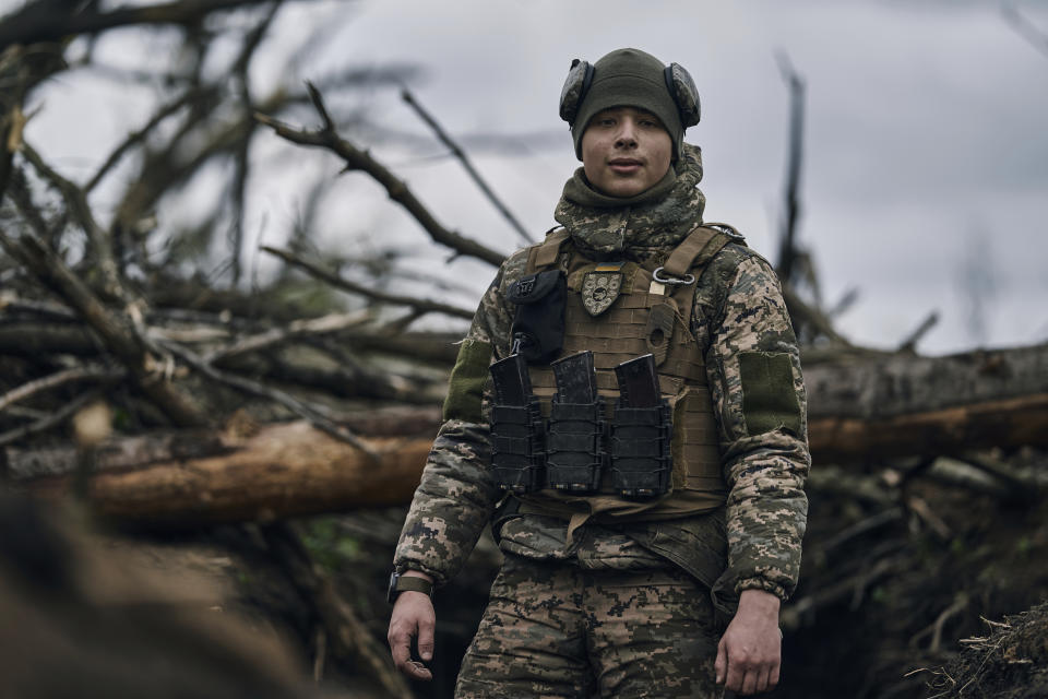 A Ukrainian soldier looks on as he stands in a trench on the frontline near Avdiivka, an eastern city where fierce battles against Russian forces have been taking place, in the Donetsk region, Ukraine, Friday, April 28, 2023. (AP Photo/Libkos)