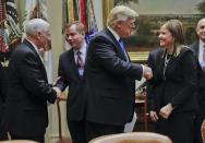 President Donald Trump, greets GM CEO Mary Barra, right, CEO of General Motors, as Vice President Mike Pence, left, greets, Matt Blunt, President of the American Automotive Policy Council, before the start of a meeting with automobile leaders in the Roosevelt Room of the White House in Washington, Tuesday, Jan. 24, 2017. (AP Photo/Pablo Martinez Monsivais)