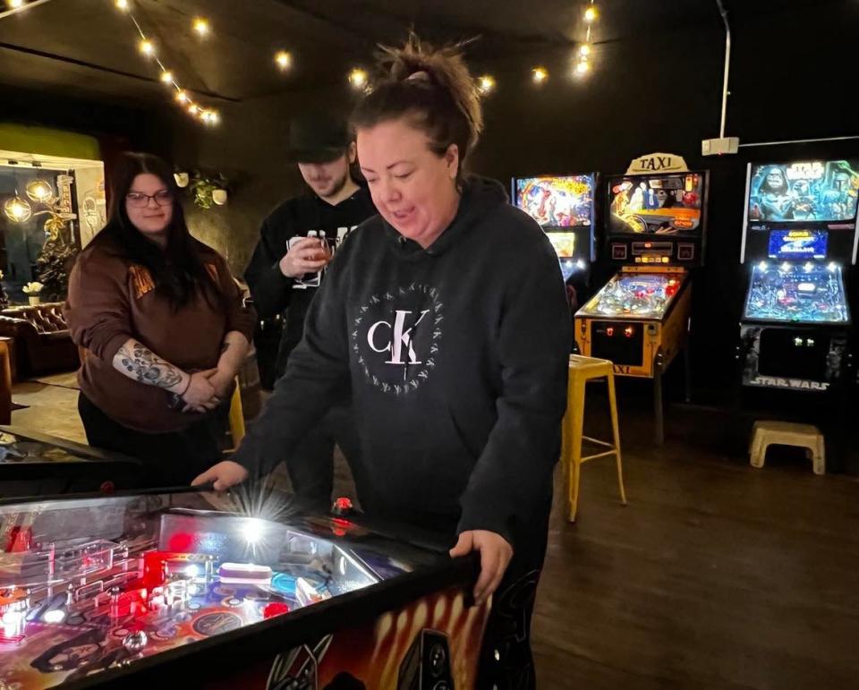 Courtney Vuoso plays a pinball game recently at the arcade at Sandy Springs Brewery Co. in downtown Minerva.