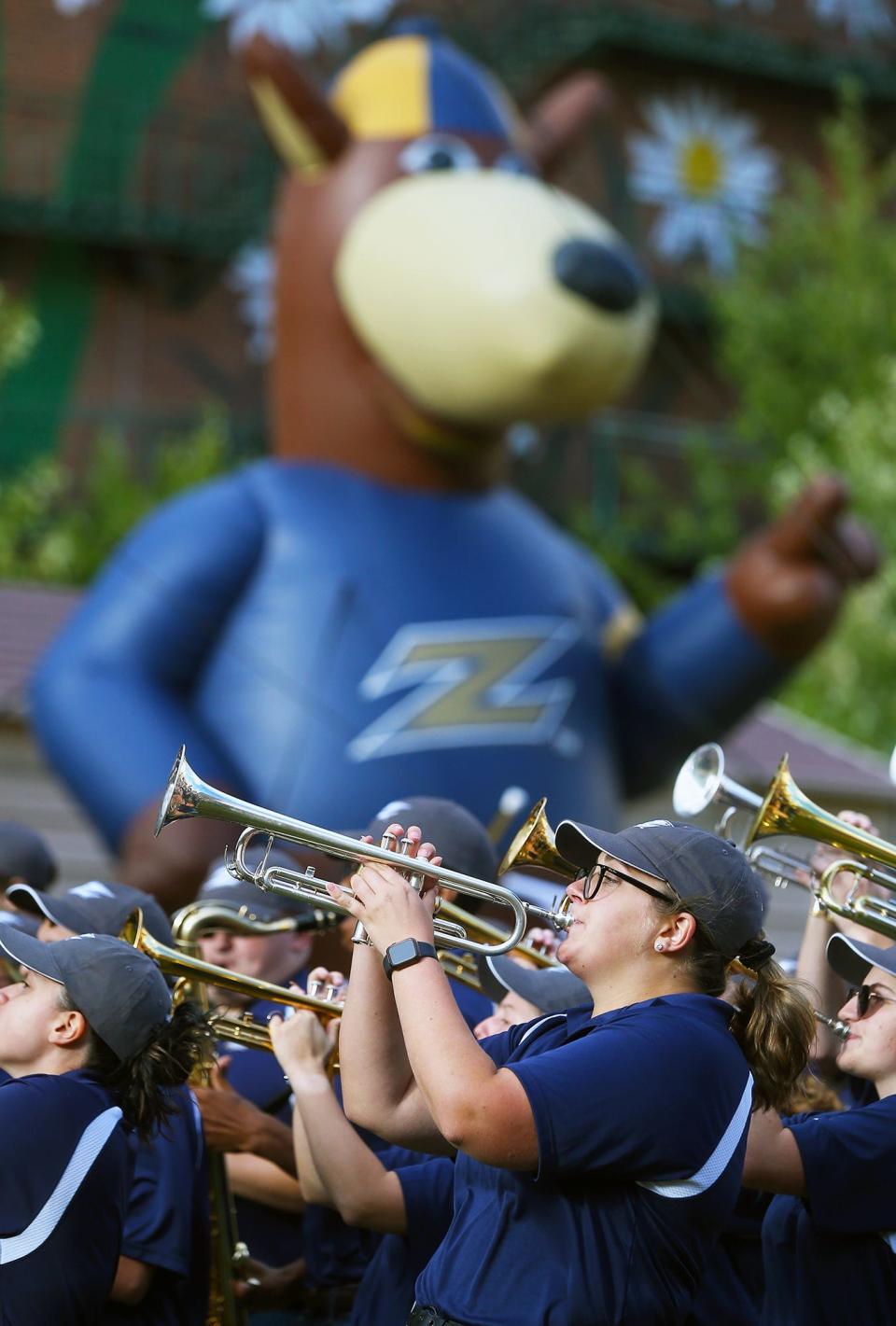 A giant inflatable Zippy appears to watch as the University of Akron marching band performs at Lock 3 Park, Tuesday, Sept. 7, 2021, in Akron, Ohio.