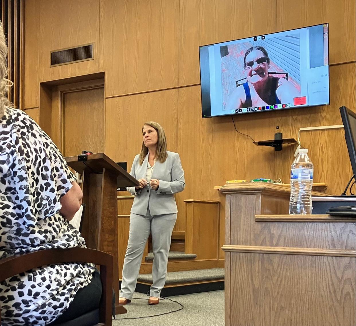 Licking County Prosecutor Jenny Wells gives her closing argument to the jury while a photo of Debra Perrine, a Newark woman murdered in December 2022, appears on the video screen.