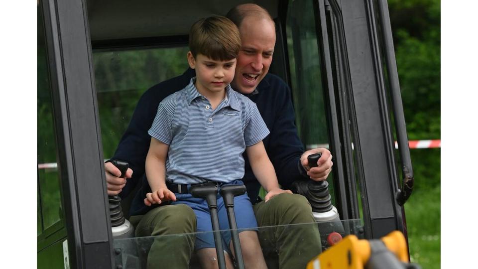 Prince William and Prince louis excavating in a digger