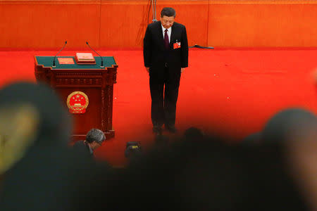 Chinese President Xi Jinping bows to the delegates after being confirmed president for another term during the fifth plenary session of the National People's Congress (NPC) at the Great Hall of the People in Beijing, China March 17, 2018. REUTERS/Thomas Peter