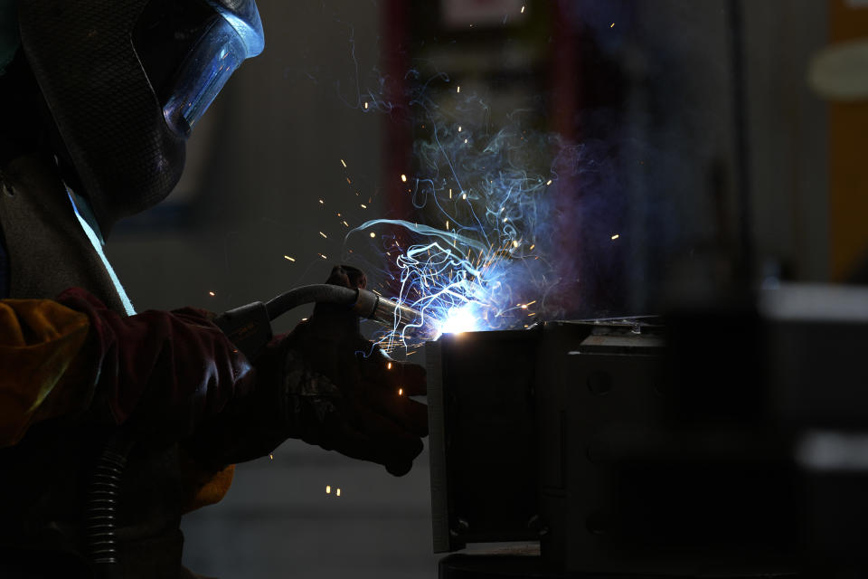 A man works at MAP, a factory operating in design, manufacture and installation of steel structures for civil and industrial use, in Corsico, near Milan, Italy, Thursday, May 12, 2022. Russia's war in Ukraine has accelerated inflation across Europe, with prices for energy, materials and food surging at rates not seen for decades. Inflation is expected to hit nearly 7% this year in the 27-nation EU and is contributing to slowing growth forecasts. (AP Photo/Antonio Calanni)