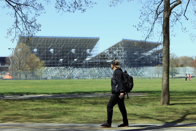 Pedestrians move past the construction site as work continues on the Nassau County International Cricket Stadium at Eisenhower Park on April 22, 2024 in East Meadow, New York. The site will be the host to the T20 Cricket World Cup 2024 in June (BRUCE BENNETT)