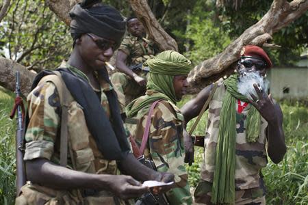 Seleka fighters roll marijuana as their commander, General Yaya, meets with Multinational Force of Central Africa (FOMAC) peacekeepers at the FOMAC camp in Bossangoa, Central African Republic, November 25, 2013. REUTERS/Joe Penney