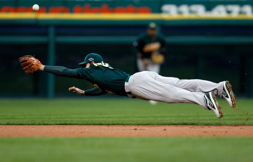 Stephen Drew #5 of the Oakland Athletics can't make a play on a ball hit in the bottom of the first inning against the Detroit Tigers during Game One of the American League Divisional Series at Comerica Park on October 6, 2012 in Detroit, Michigan. (Photo by Gregory Shamus/Getty Images)