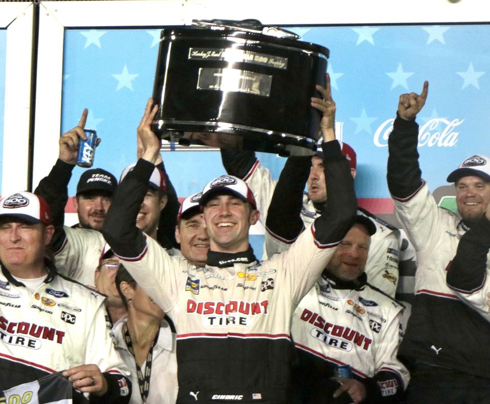 Austin Cindric lifts the Daytona 500 Trophy high in Victory Lane, Sunday night February 20, 2022 at Daytona International Speedway.