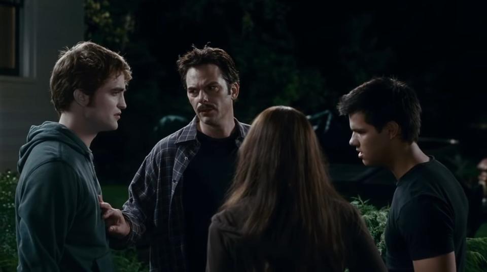 Robert Pattinson as Edward, Billy Burke as Charlie, Kristen Stewart as Bella, and Taylor Lautner as Jacob in "Eclipse."