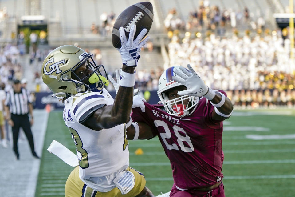 Georgia Tech wide receiver Eric Singleton Jr. (13) misses a catch in the end zone as South Carolina State defensive back Michael Brunson (28) defends during the second half of an NCAA college football game, Saturday, Sept. 9, 2023, in Atlanta. Georgia Tech won 48-13. (AP Photo/Mike Stewart)