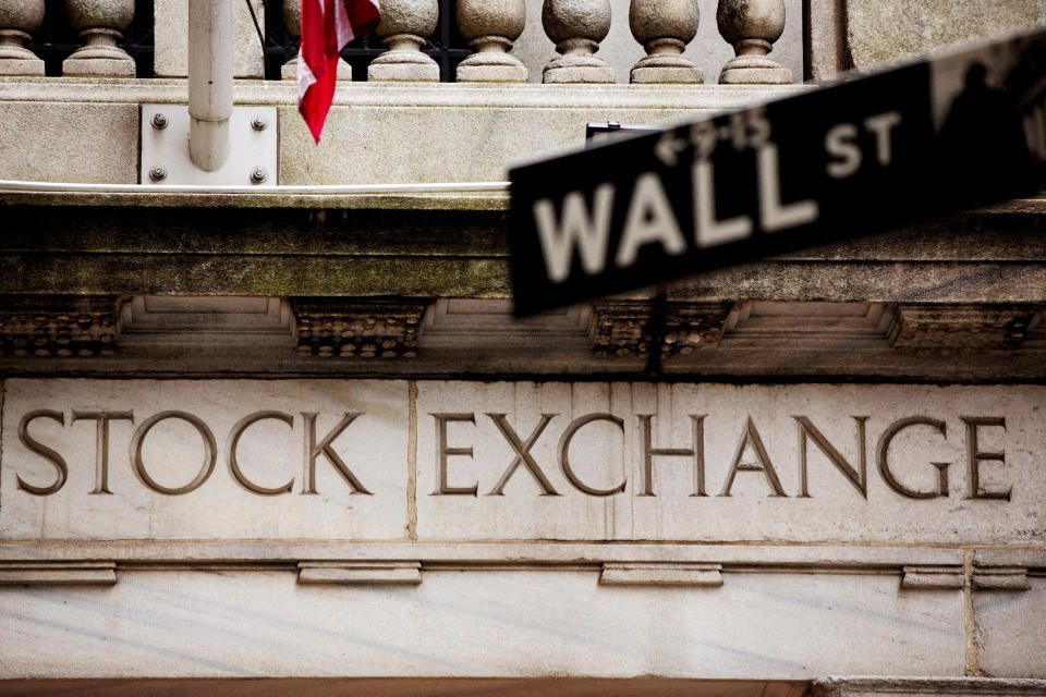 FILE PHOTO: A street sign for Wall Street hangs in front of the New York Stock Exchange May 8, 2013. REUTERS/Lucas Jackso//File Photo