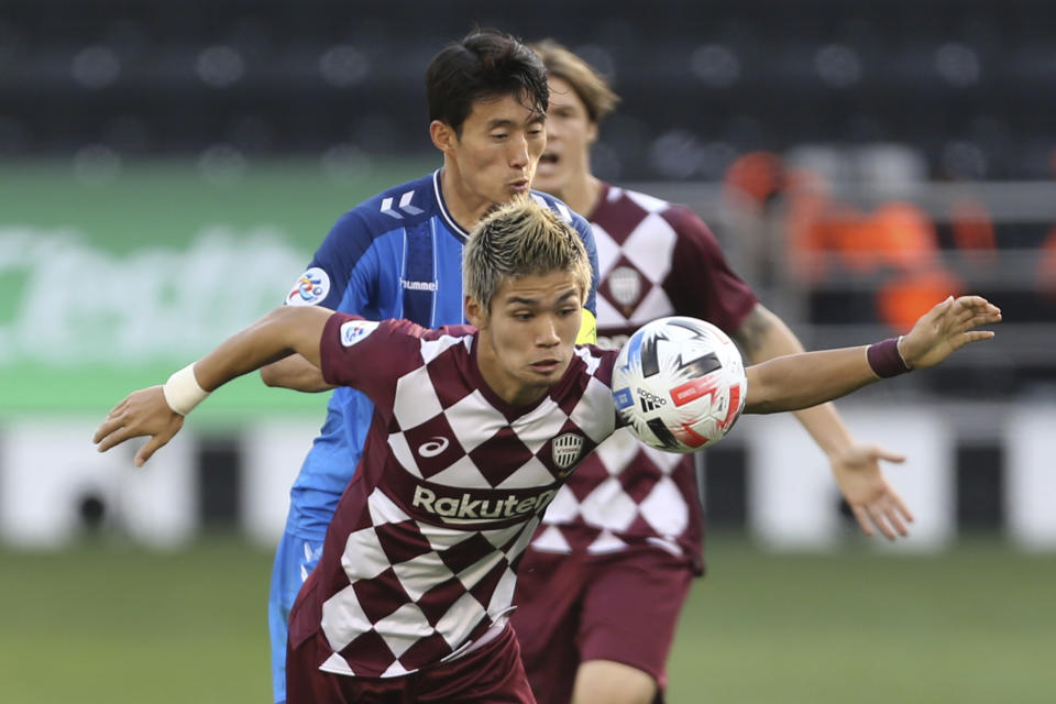 Vissel Kobe's Daiju Sasaki, foreground, is challenged by Ulsan Hyundai's Sin Jin-Ho during the Champions League semifinal soccer match between Vissel Kobe and Ulsan Hyundai FC at Jassim Bin Hamad Stadium in Doha, Qatar, Sunday, Dec. 13, 2020. (AP Photo/Hussein Sayed)