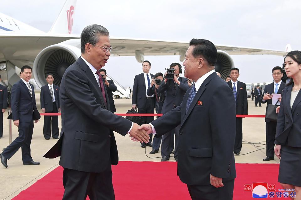 In this photo provided on April 12, 2024, by the North Korean government, Choe Ryong Hae, front right, vice-chairman of the central committee of the Workers' Party of North Korea, shakes hands with Zhao Leji, center left, chairman of the National People’s Congress of China, as Zhao and other delegates arrive at the Pyongyang International Airport in Pyongyang, North Korea, Thursday, April 11, 2024. Korean language watermark on image as provided by source reads: "KCNA" which is the abbreviation for Korean Central News Agency. (Korean Central News Agency/Korea News Service via AP)