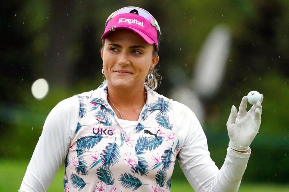 Lexi Thompson holds up her ball after finishing on the 18th hole during the third round of the LPGA Cognizant Founders Cup golf tournament, Saturday, May 14, 2022, at the Upper Montclair Country Club in Clifton, N.J. (AP Photo/John Minchillo)