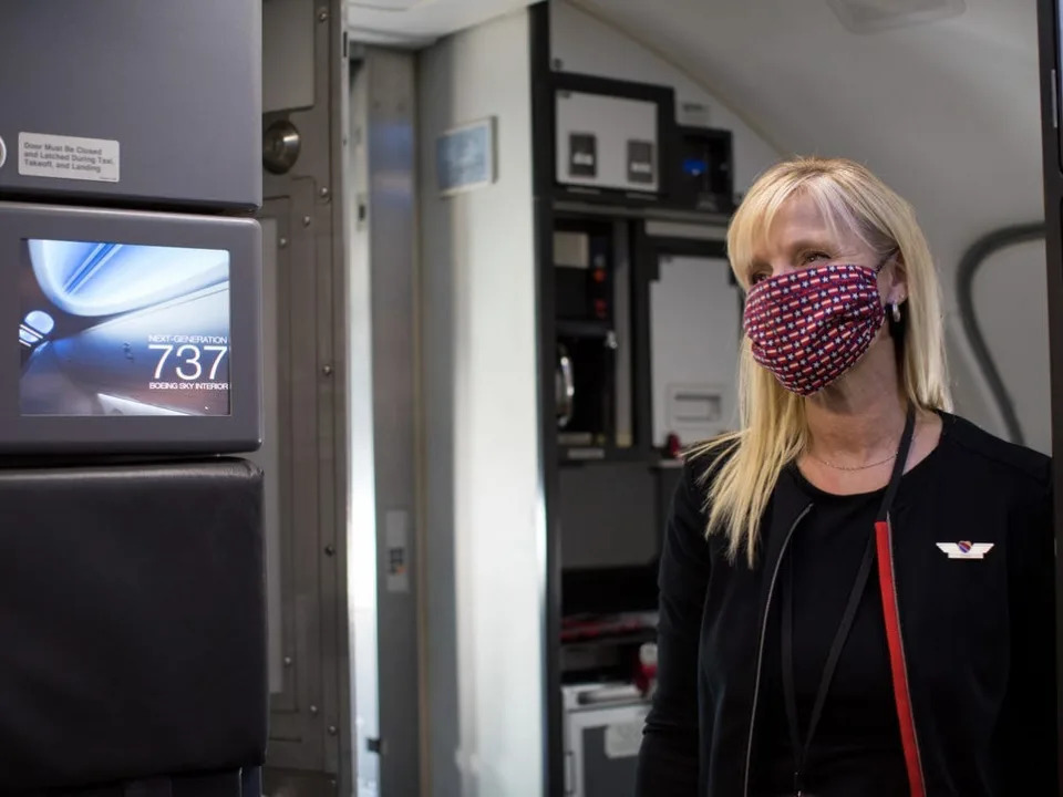 Southwest flight attendant greets passengers during the pandemic