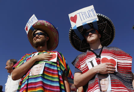 Supporters of Donald Trump hold their hands over their hearts during the U.S. National Anthem at a Trump campaign rally in Fountain Hills, Arizona. REUTERS/Ricardo Arduengo