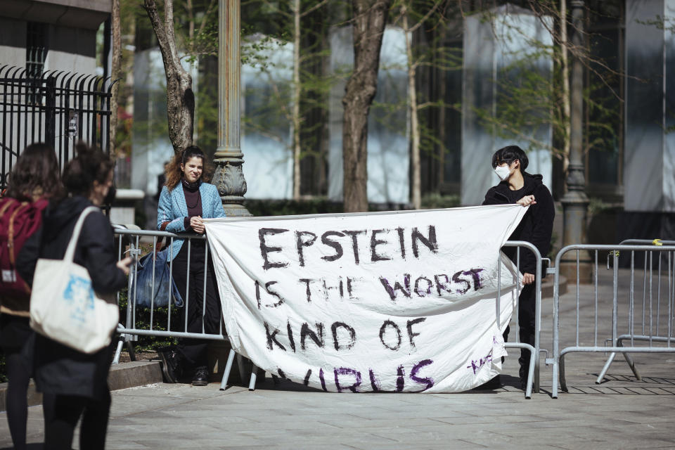Activists protesting Jeffrey Epstein's associate Ghislaine Maxwell stand in front of Federal Court on Friday, April 23, 2021, in New York. Ghislaine Maxwell, a British socialite and one-time girlfriend of Epstein, pleaded not guilty to sex trafficking conspiracy and an additional sex trafficking charge that were added in a rewritten indictment released last month by a Manhattan federal court grand jury. (AP Photo/Kevin Hagen)