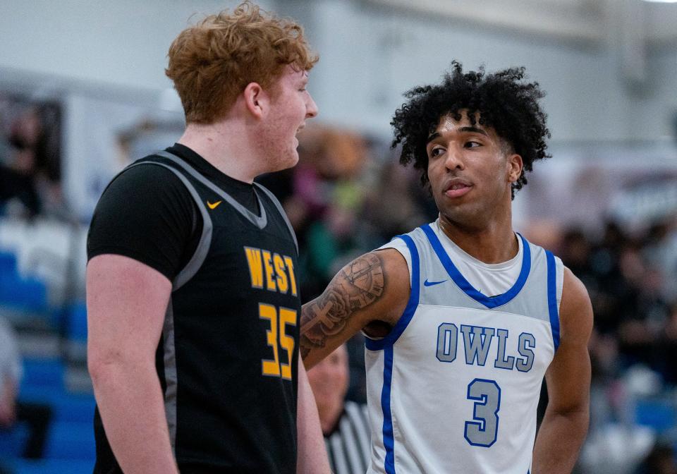 Central Bucks West's Sam Jankowski (35) talks to Bensalem's Micah White (3) at the free-throw line during the teams' first-round game in the Suburban One League Tournament.