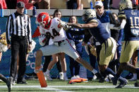 Georgia wide receiver Ladd McConkey (84) scores after a catch as Georgia Tech defensive back Juanyeh Thomas (1) defense in in the second half of an NCAA college football game Saturday, Nov. 27, 2021, in Atlanta. (AP Photo/John Bazemore)