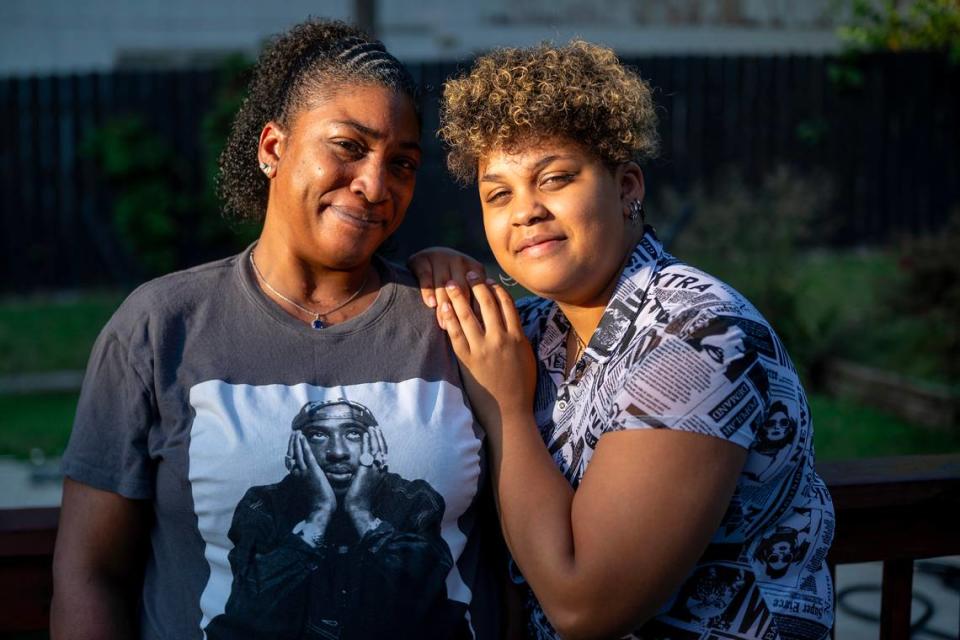 Kearra Adams poses with her daughter, Tranae outside of their home in Raytown. After they were hit by a driver fleeing police, the family’s medical bills totaled more than $2 million. 