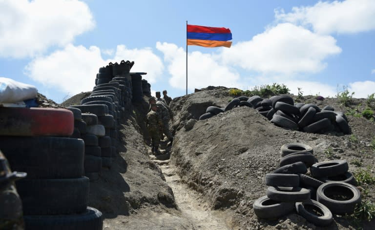 Soldiers walk in a trench at a border checkpoint between Armenia and Azerbaijan near the village of Sotk, Armenia, on June 18, 2021 (Karen MINASYAN)