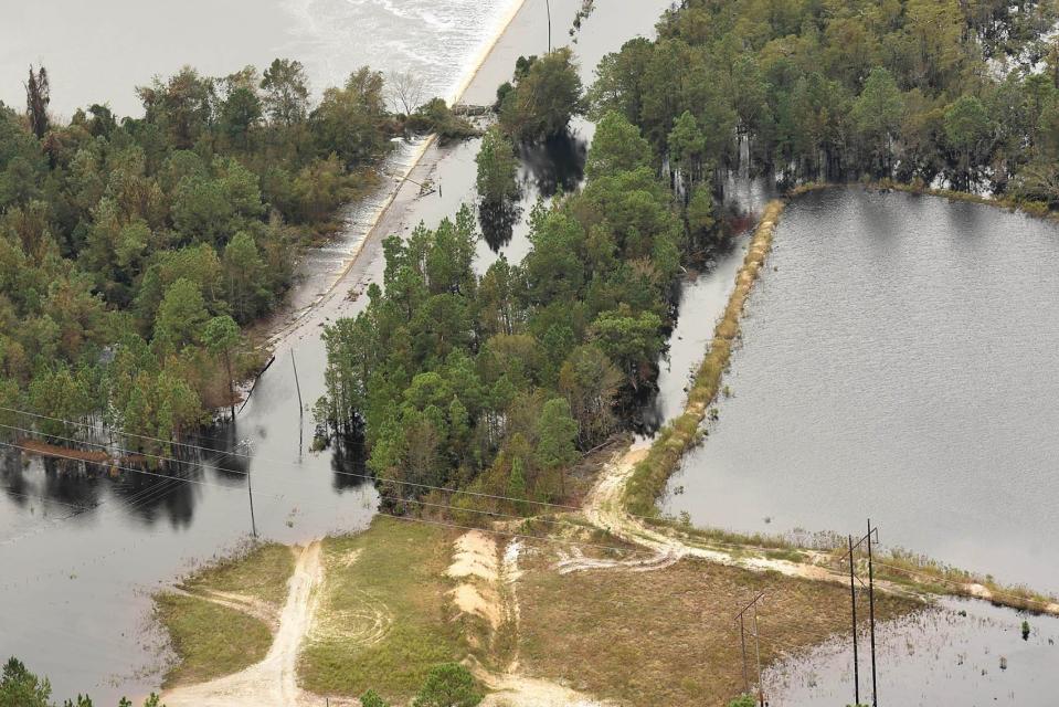 Flood waters spill over HWY 421 near Wilmington, N.C. Monday Sept. 24, 2018 after waters from Sutton Lake breached the lake.. [KEN BLEVINS/STARNEWS]